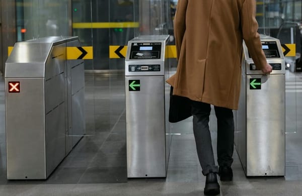Man is granted to access through a barrier by presented his access card.